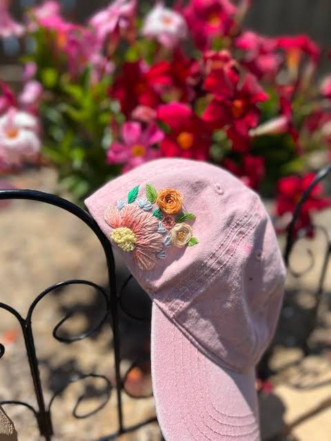Floral side design cap embroidery digitizing on a pink hat