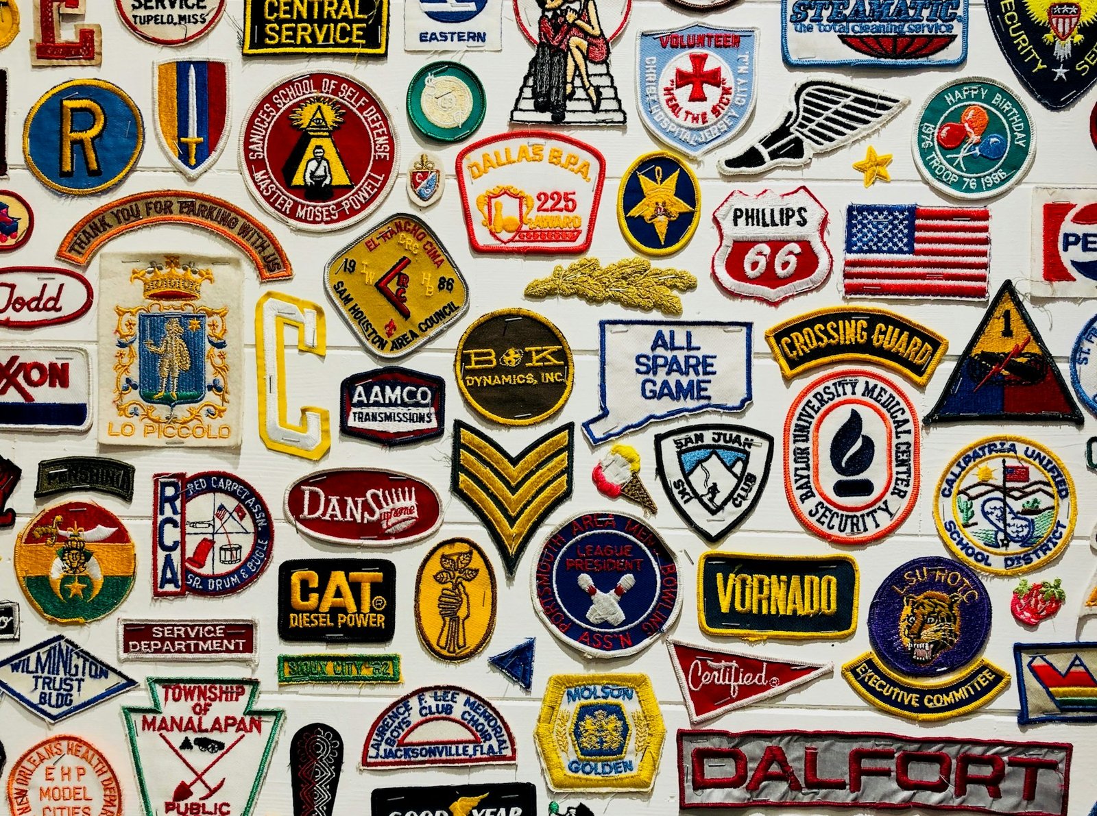 Wall of embroidered company logos from the Amazing Punch digitizing desk