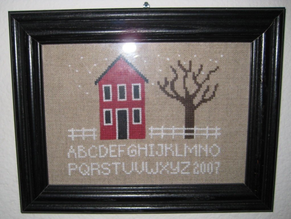 Cross stitch house sampler used as a logo digitizing reference