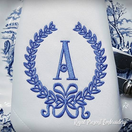 Blue letter A laurel wreath and bow monogram embroidery digitizing sample